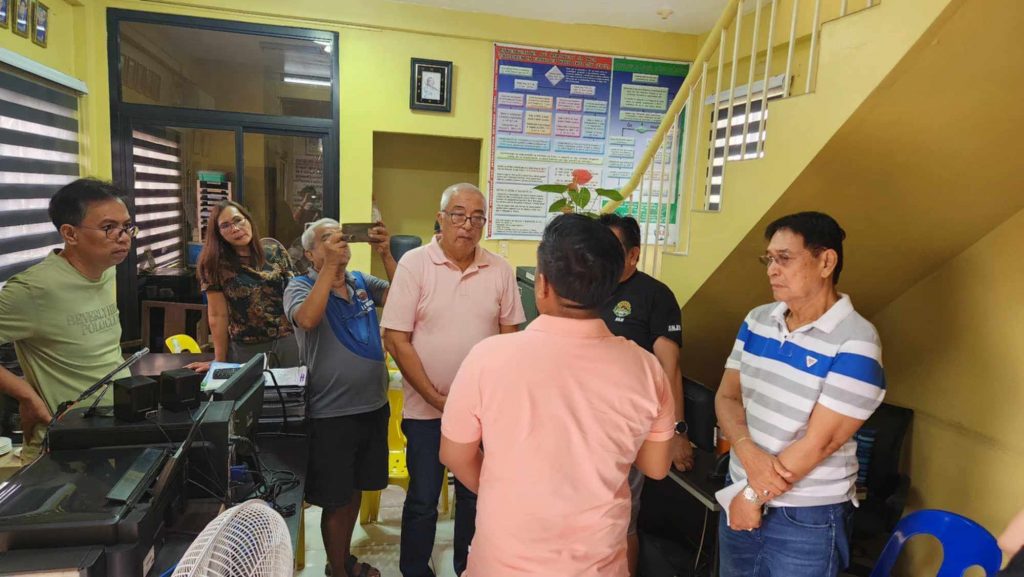 Government officials from Senator Bong Go’s office and DTI-Laguna provide relief assistance and introduce livelihood recovery programs to fire victims at Santa Cruz public market, highlighting the Pangkabuhayan sa Pagbangon at Ginhawa initiative and collaborative disaster response efforts.