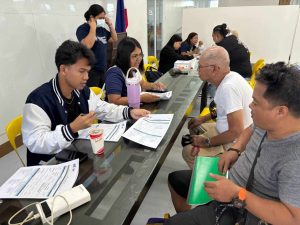 DTI-Laguna personnel conducting profiling and validation interviews with fire-affected vendors at the Santa Cruz Municipal Auditorium under the Pangkabuhayan sa Pagbangon at Ginhawa (PPG) Program.